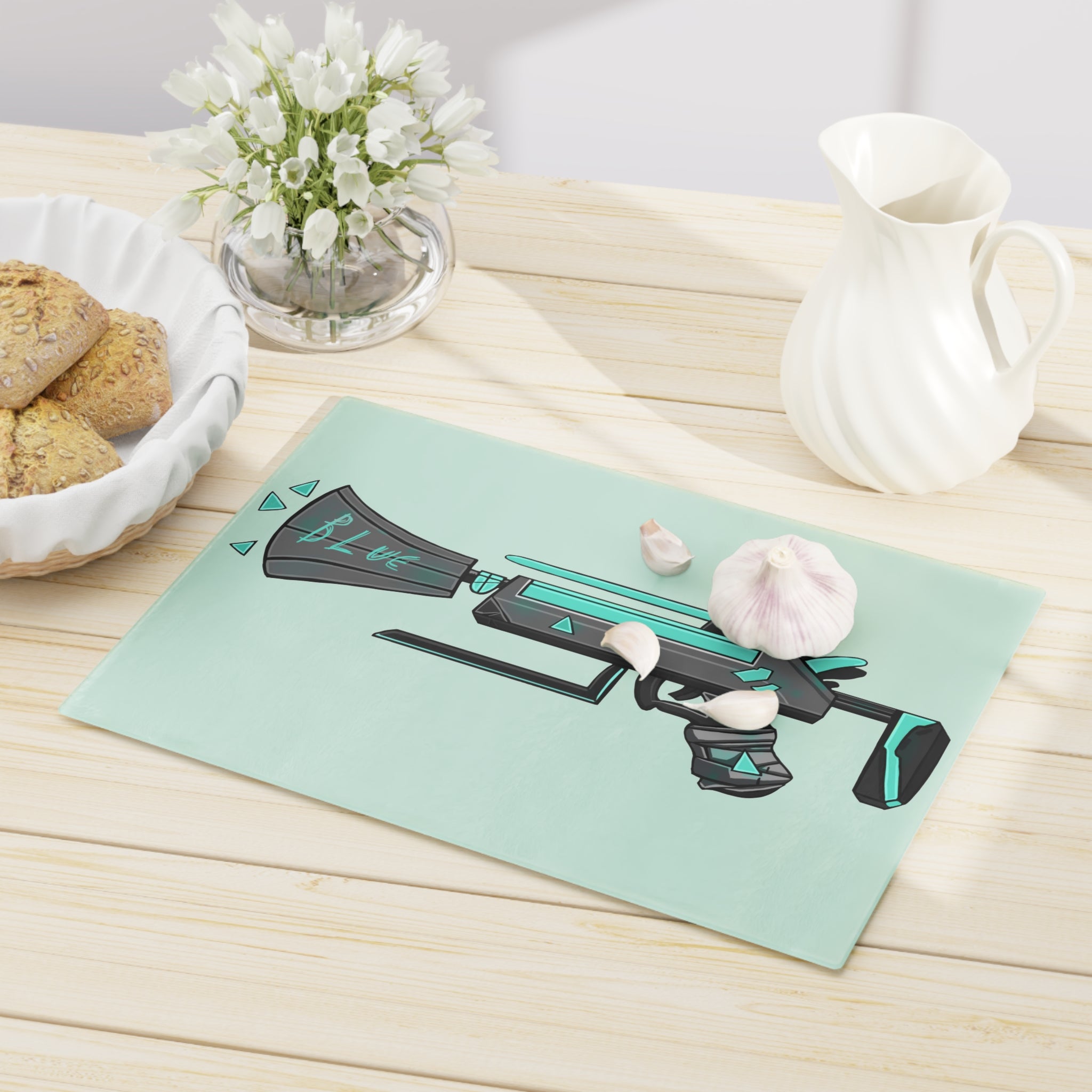 Blue Gun Cutting Board made of tempered glass with rubber dots for stability, showcasing a unique design.