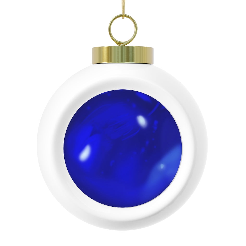 A beautiful blue ceramic Christmas ball ornament with a glossy finish, featuring a gold ribbon for hanging and a vintage design.