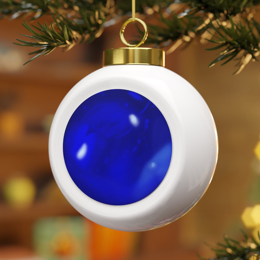 A beautiful blue ceramic Christmas ball ornament with a glossy finish, featuring a gold ribbon for hanging and a vintage design.