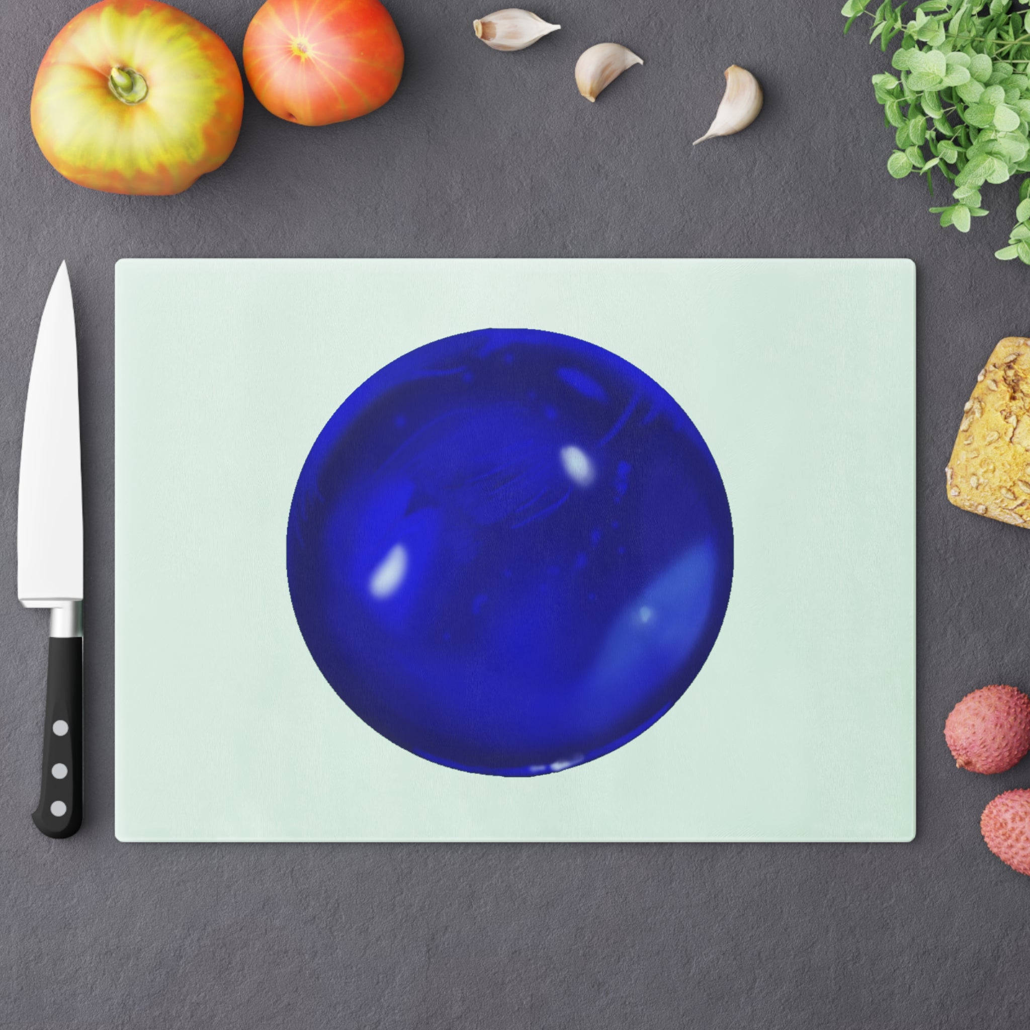 Blue Orb Cutting Board made of tempered glass with rubber dots for stability, showcasing a unique design perfect for kitchen use.