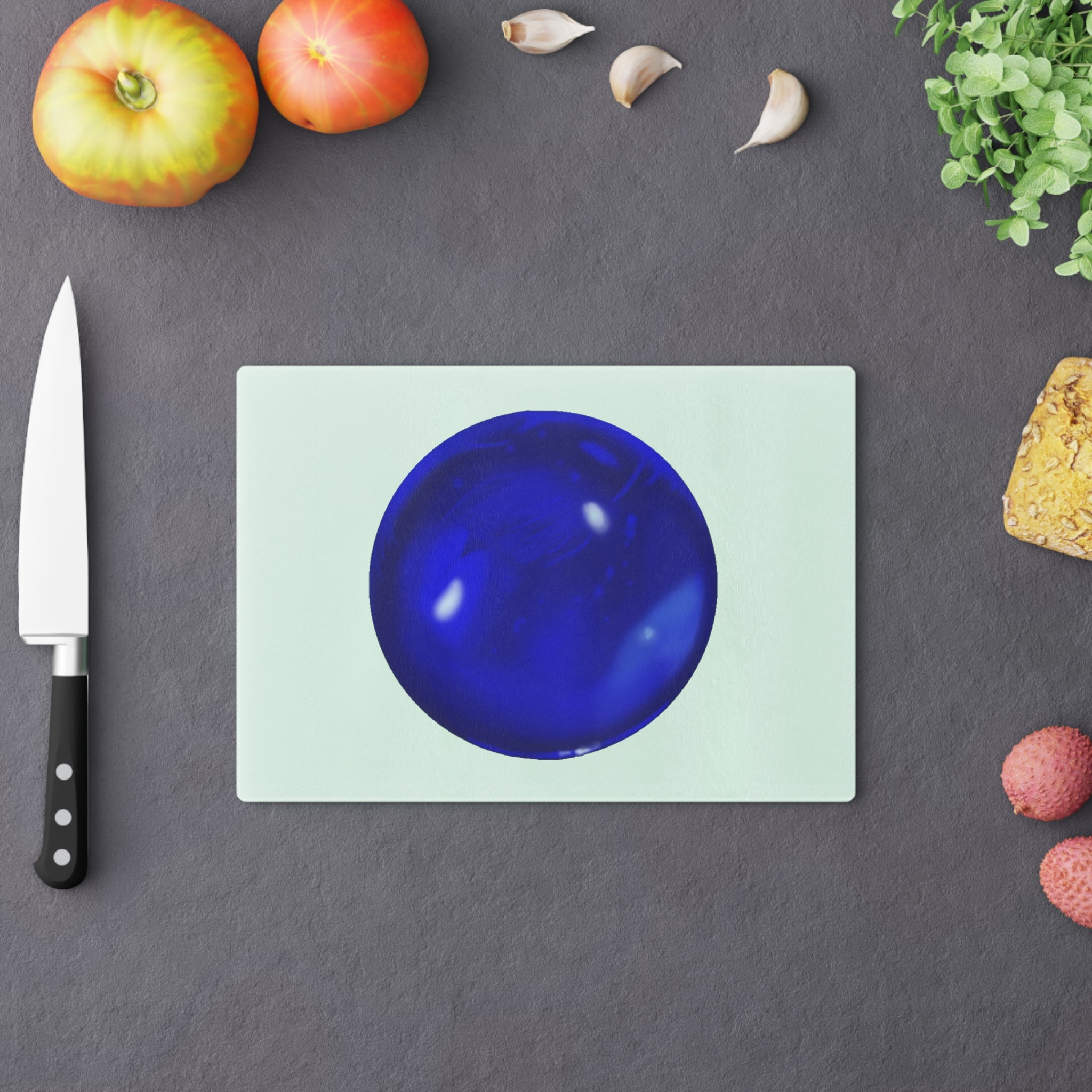 Blue Orb Cutting Board made of tempered glass with rubber dots for stability, showcasing a unique design perfect for kitchen use.