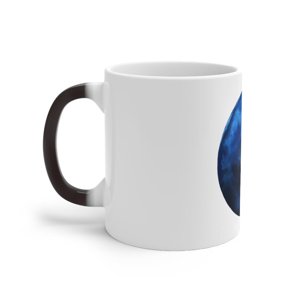 A blue ceramic mug that changes color when filled with hot liquid, showcasing its unique design and C-handle.