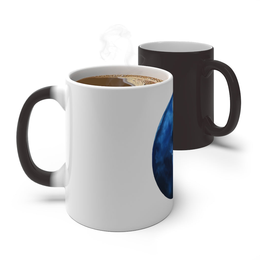 A blue ceramic mug that changes color when filled with hot liquid, showcasing its unique design and C-handle.