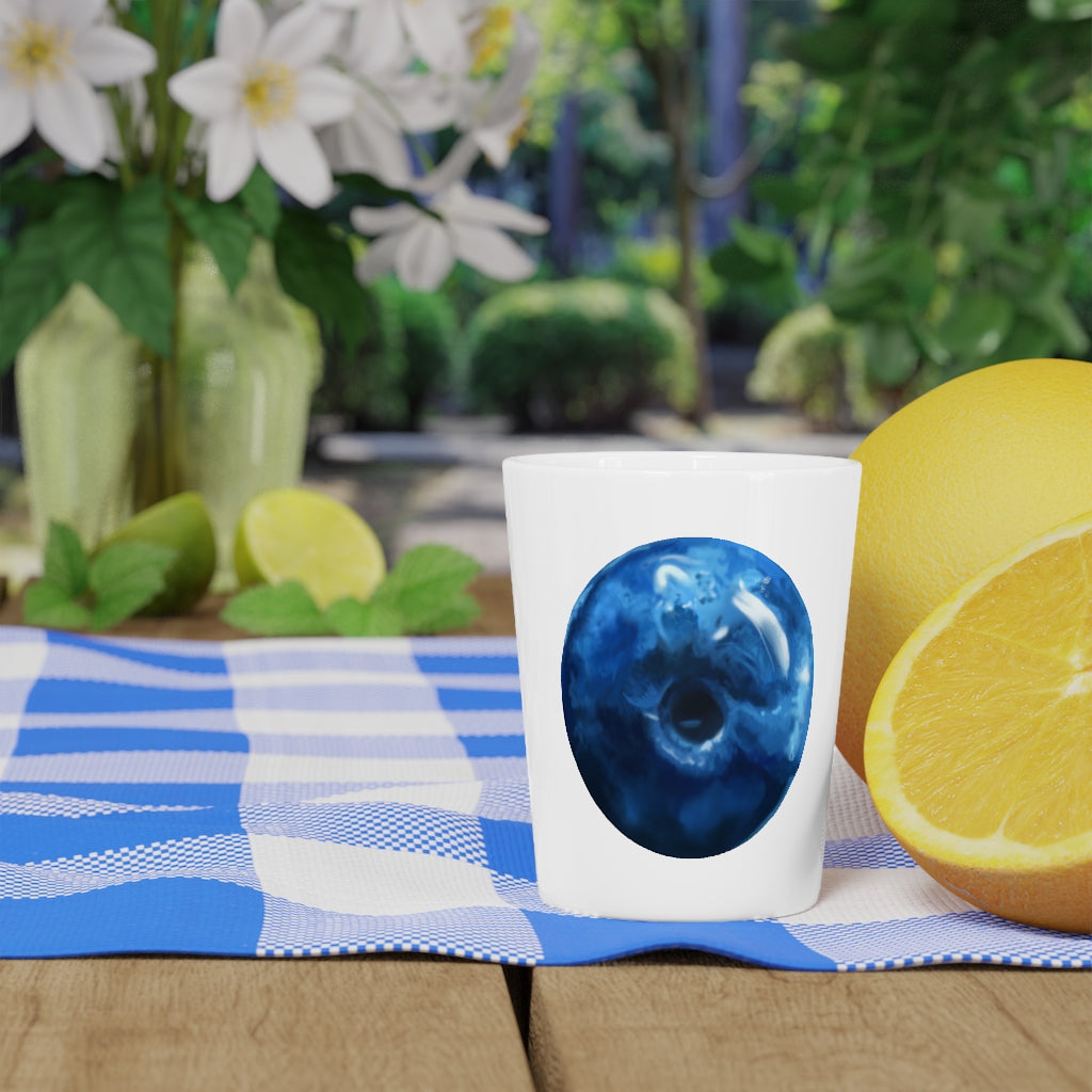 A stylish Blueberry Shot Glass made of ceramic, featuring a customizable design with a white or black interior, perfect for gatherings and gifts.