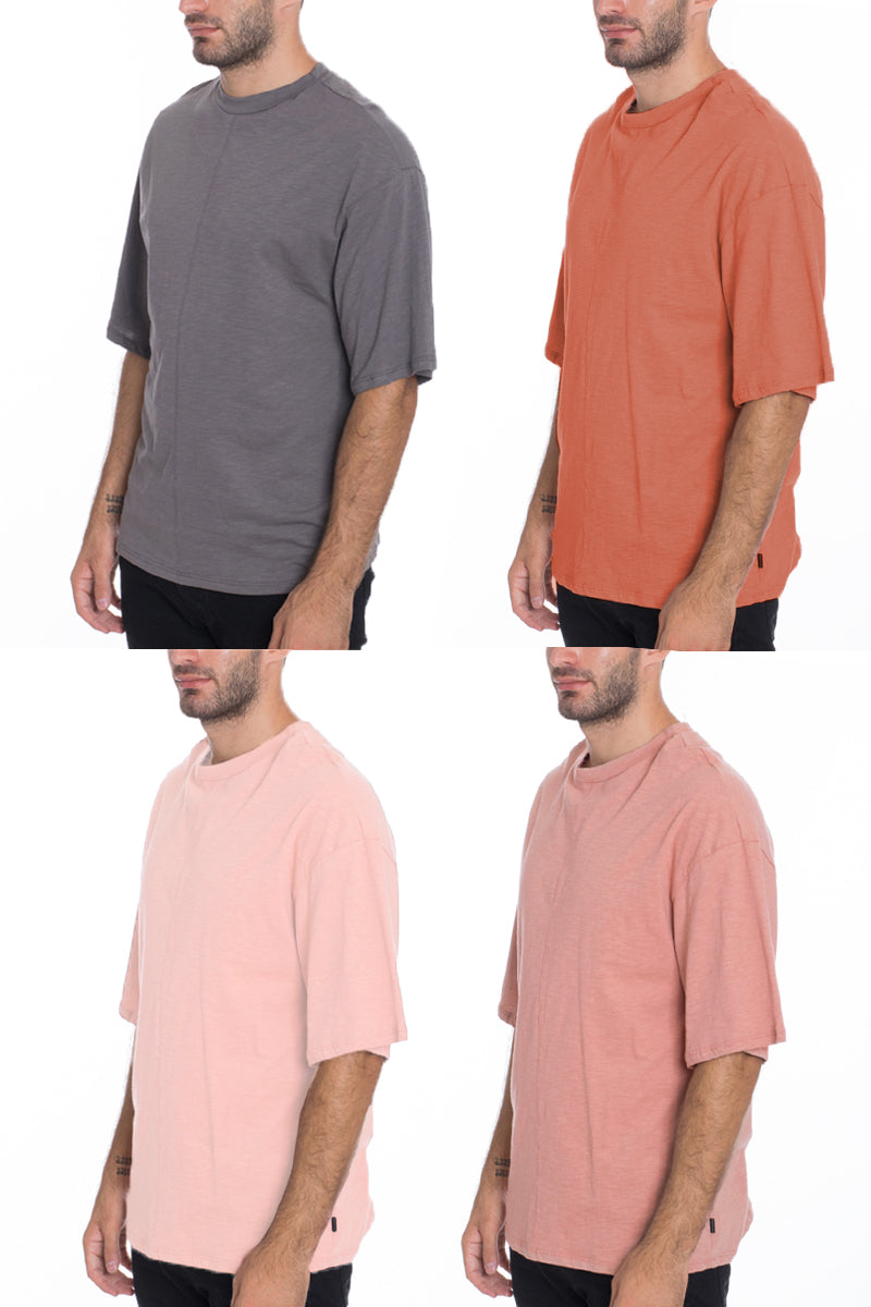 A stylish Box Tee made of 100% cotton, featuring a center seam and elbow-length sleeves, displayed on a model.