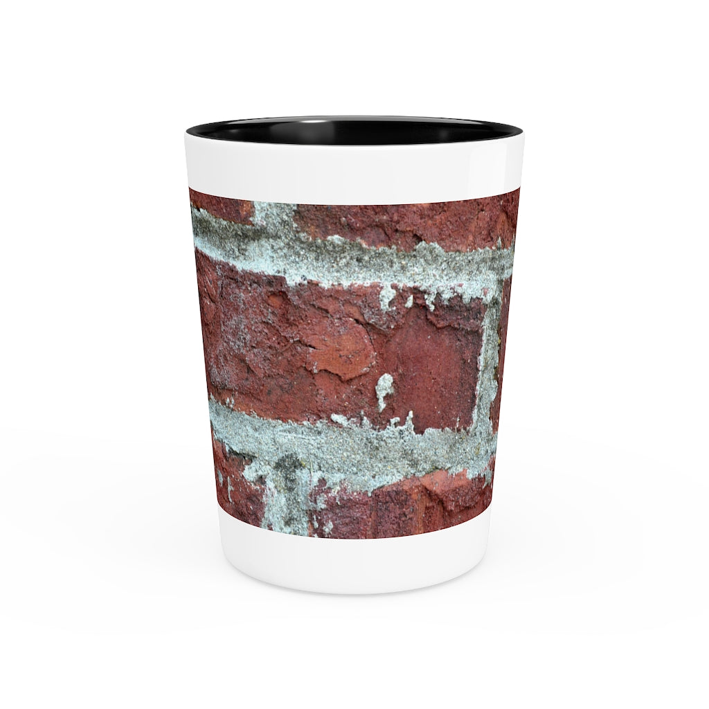 A personalized Brick Shot Glass made of white ceramic with a customizable design, featuring a black interior.