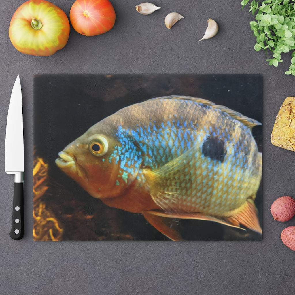 Brown and orange fish design tempered glass cutting board with rubber dots for stability.