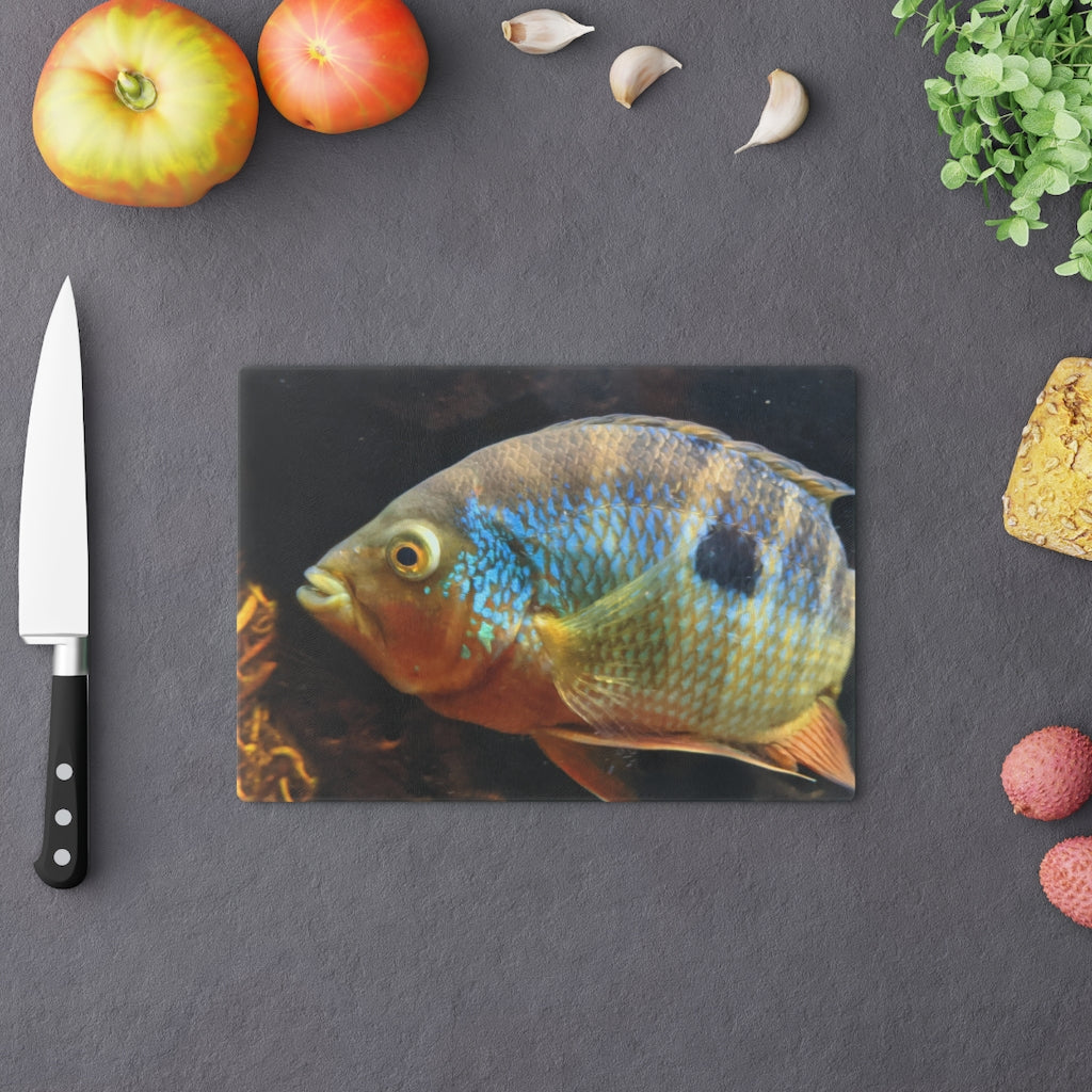 Brown and orange fish design tempered glass cutting board with rubber dots for stability.