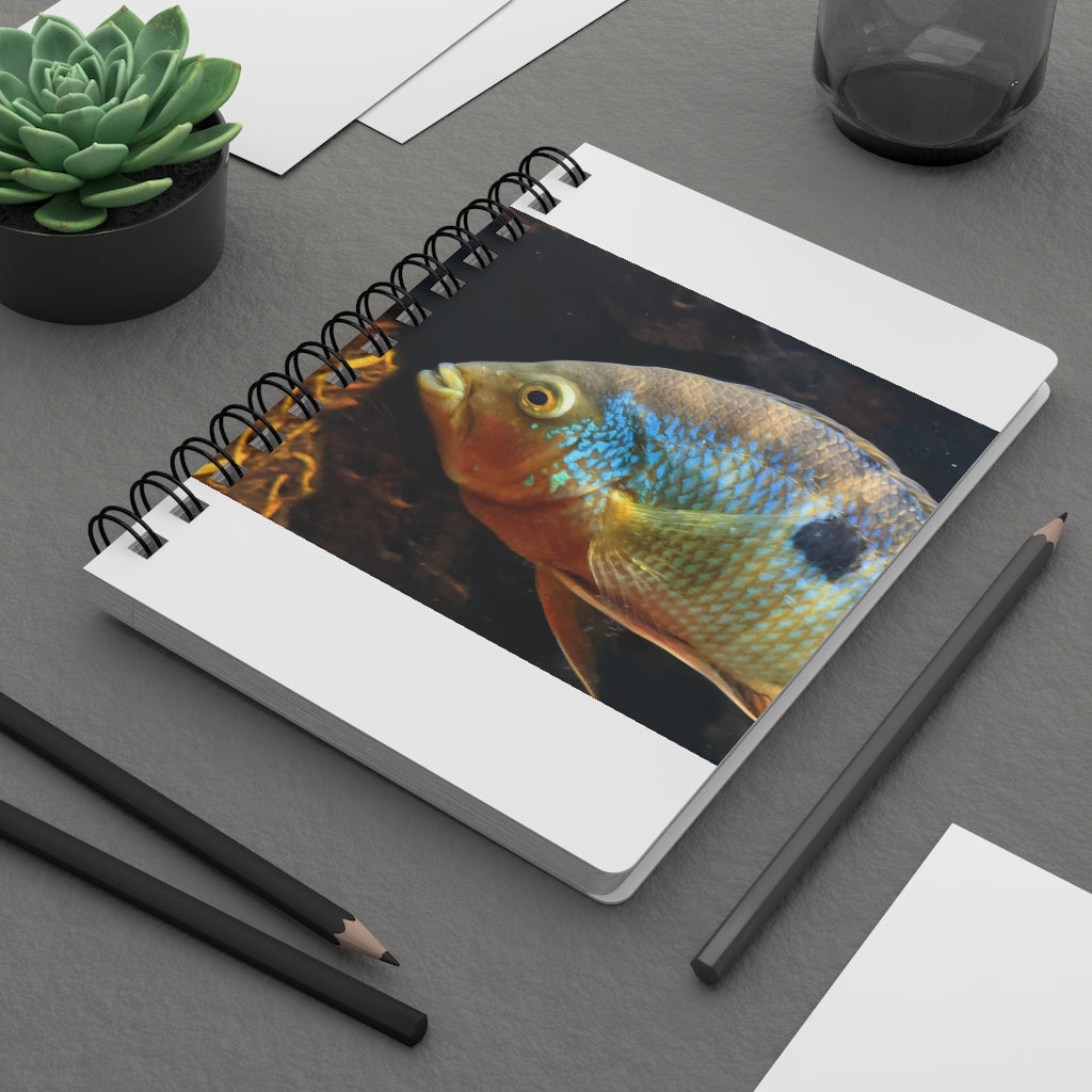 Brown and orange spiral bound journal featuring a vibrant fish design on the cover, with a glossy laminated finish and lined pages inside.