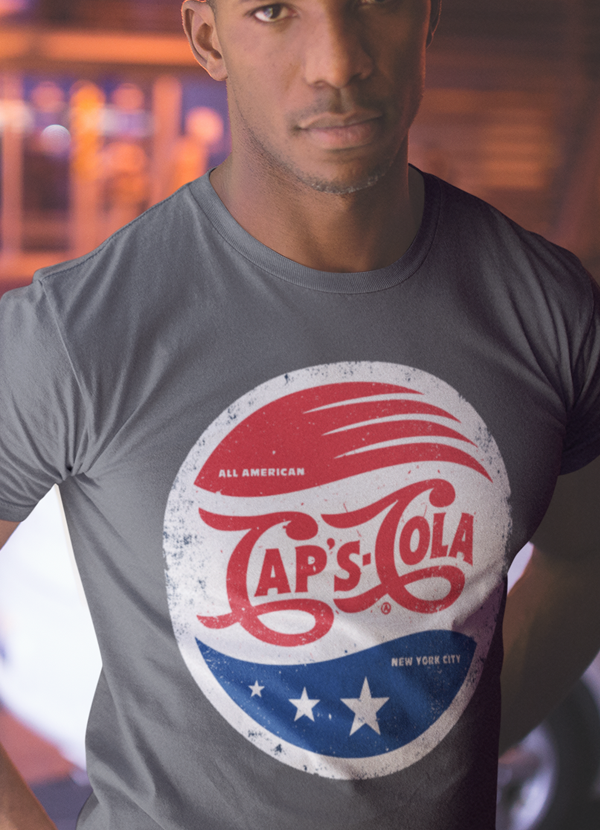 Caps Cola T-shirt featuring unique artistic design on soft ringspun cotton fabric.