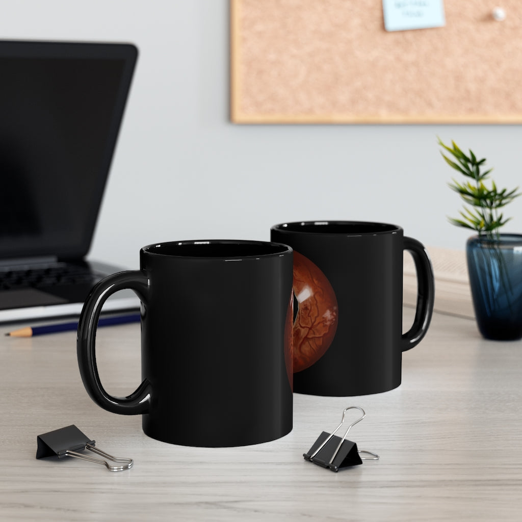 A stylish Cat Eyes 11oz black ceramic mug with a C-handle, perfect for coffee, tea, or hot chocolate.