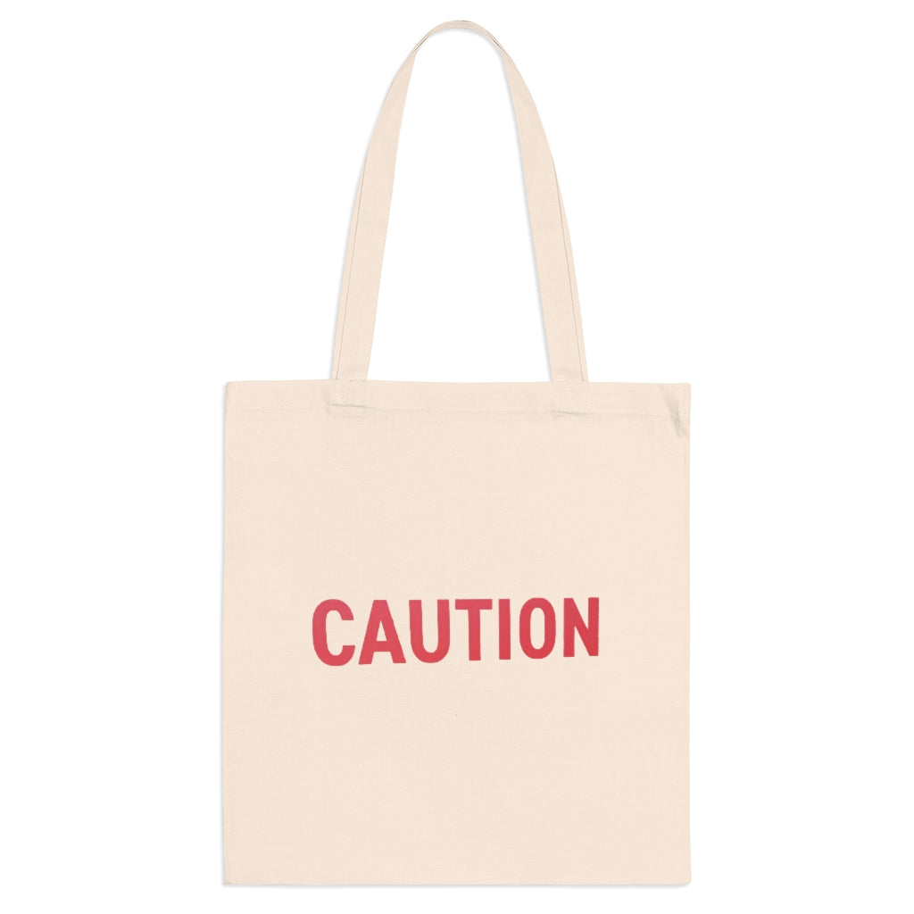 Caution Tote Bag made of 100% cotton with long handles and cross-stitched detailing, available in multiple colors.