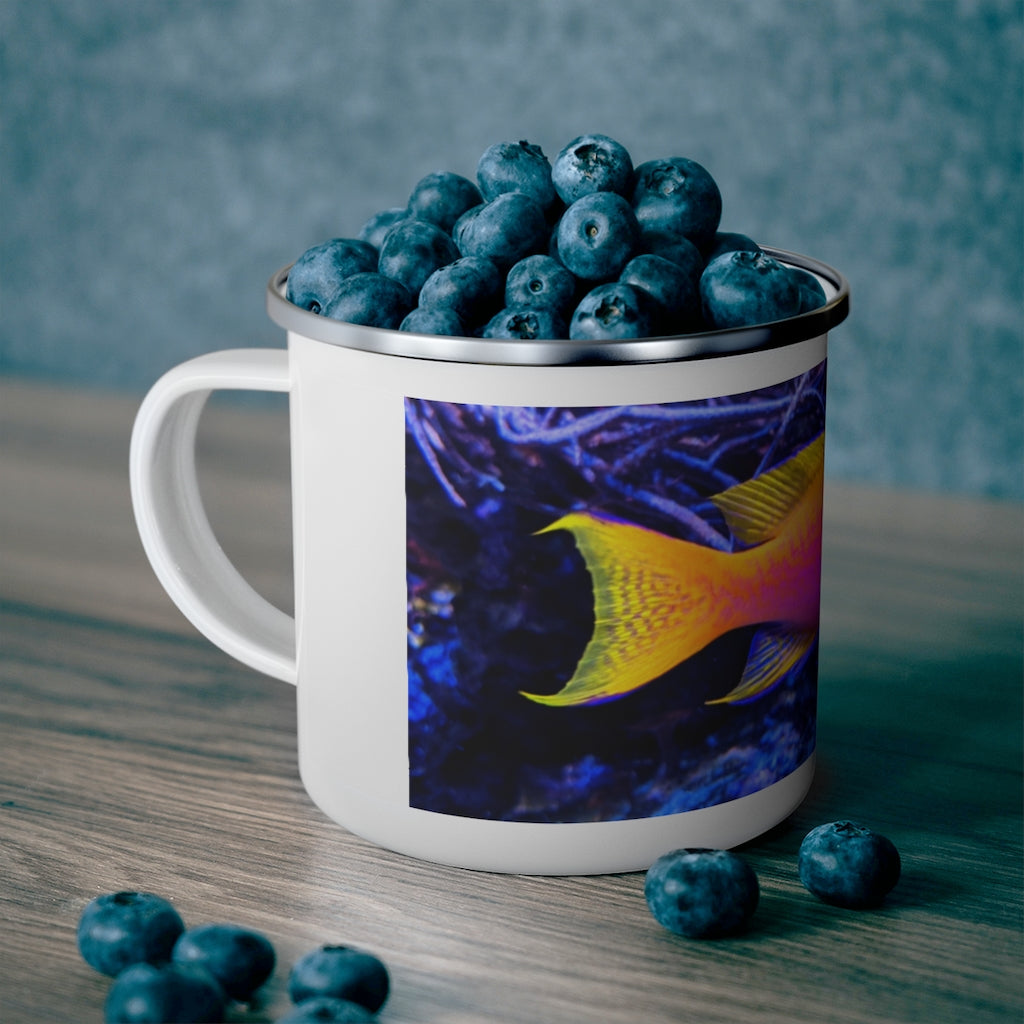 A colorful enamel camping mug featuring a fish design, perfect for outdoor use, showcasing its sturdy stainless steel construction and C-handle.