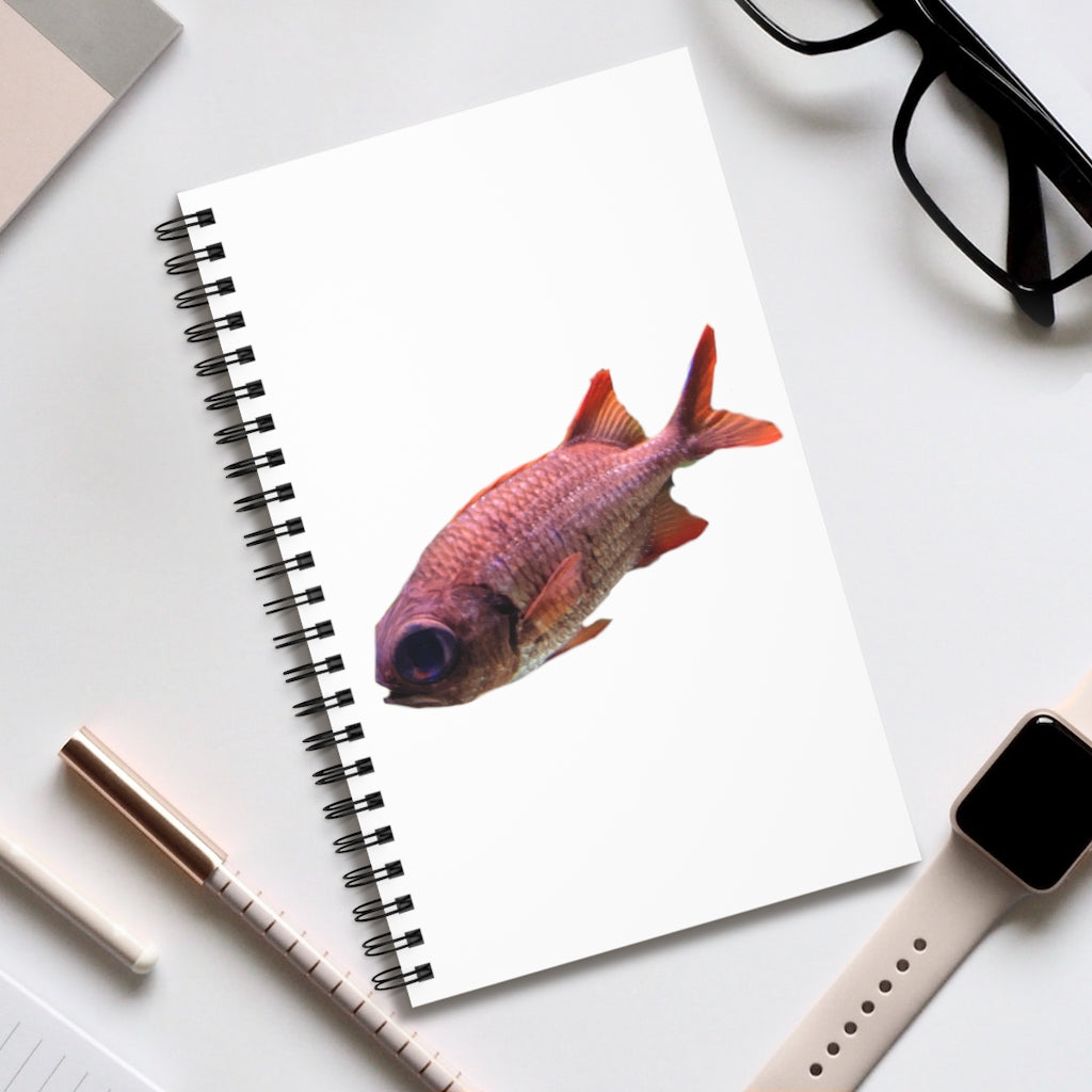 A colorful spiral journal featuring a vibrant fish design on the cover, showcasing various styles including blank, dot grid, lined, and task layouts.