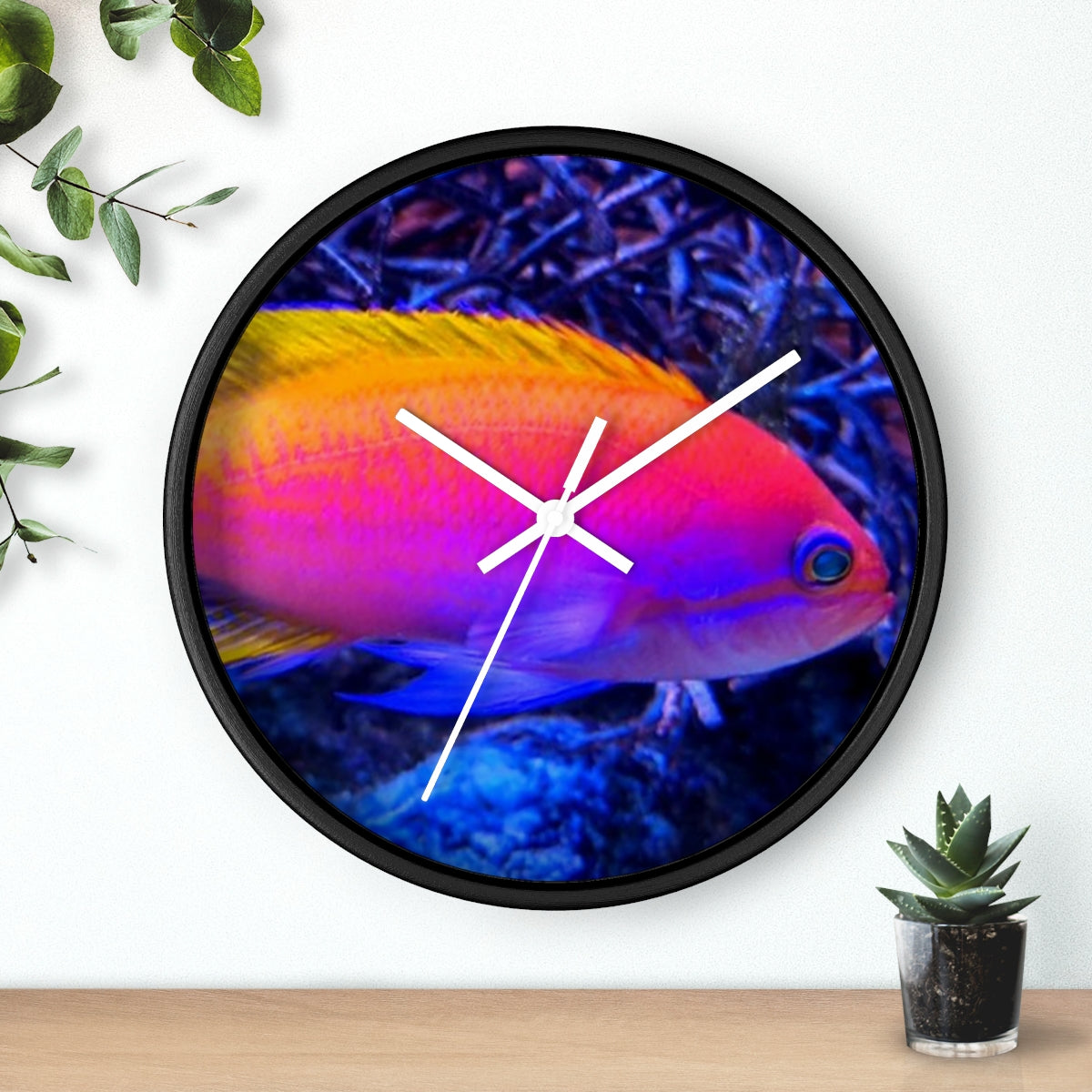 A colorful wall clock featuring vibrant fish designs in a wooden frame, perfect for indoor decor.