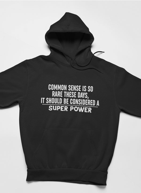 A stylish hoodie featuring the phrase 'Common Sense Should Be Considered A Superpower', designed by top artists, showcasing a cozy fleece material.