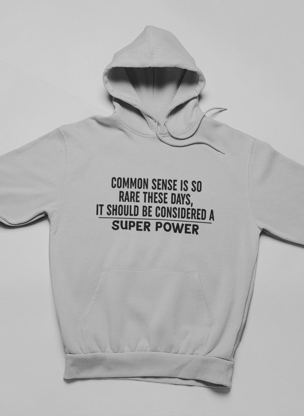 A stylish hoodie featuring the phrase 'Common Sense Should Be Considered A Superpower', designed by top artists, showcasing a cozy fleece material.