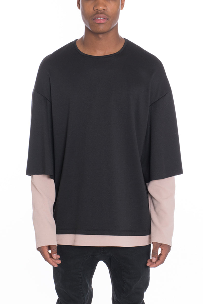 Cortez Slouch Long Sleeve t-shirt featuring a two-tone design with long sleeves attached to short sleeves, modeled by a woman.