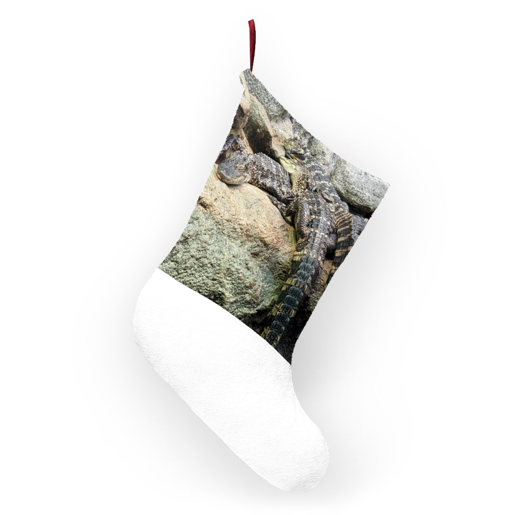 A cozy Crocodiles Christmas Stocking made of soft polyester fleece, featuring a festive design and a twill ribbon hanging loop.