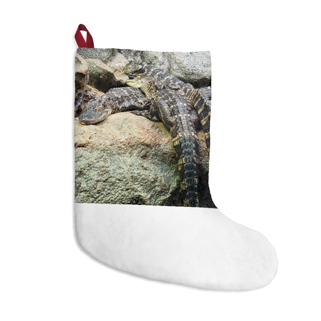 A cozy Crocodiles Christmas Stocking made of soft polyester fleece, featuring a festive design and a twill ribbon hanging loop.