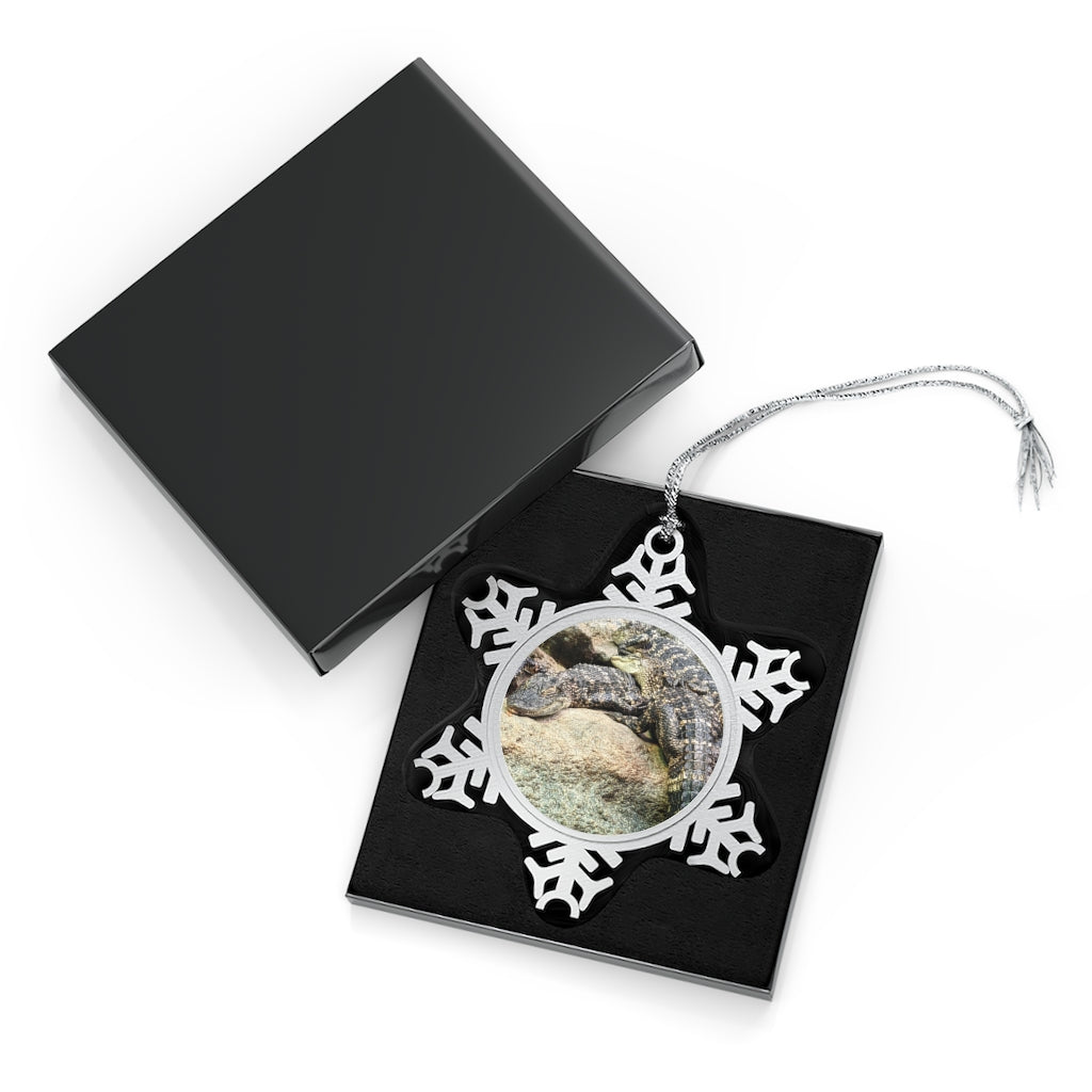 Crocodiles Pewter Snowflake Ornament with silver-toned hanging string, showcasing intricate snowflake design.