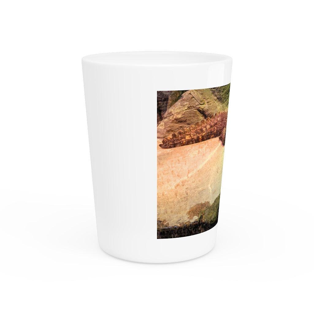 A personalized Crocodiles shot glass made of ceramic, featuring a sleek design with a white or black interior.