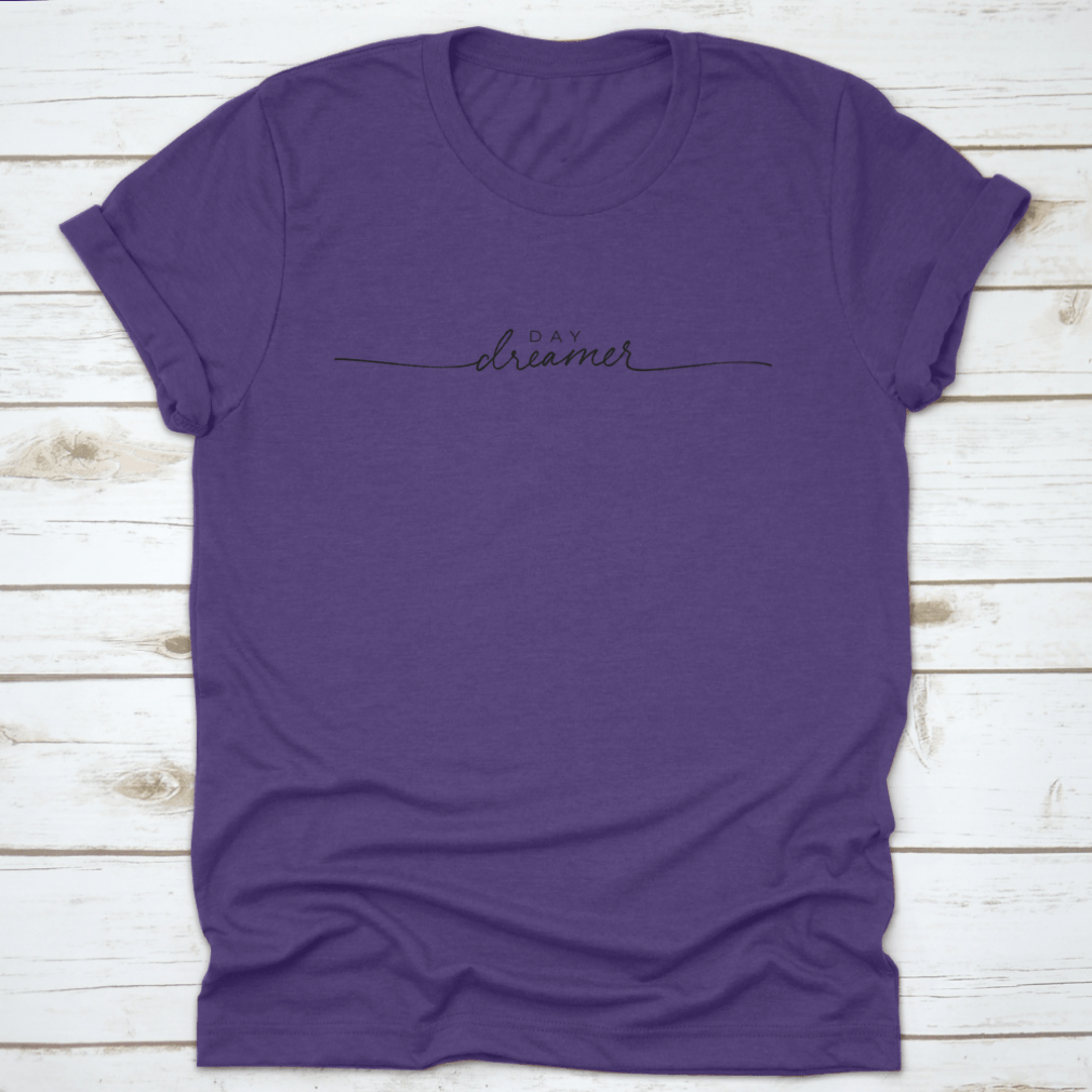 A stylish t-shirt featuring hand-drawn Day Dreamer vector line calligraphy lettering, showcasing creativity and comfort.