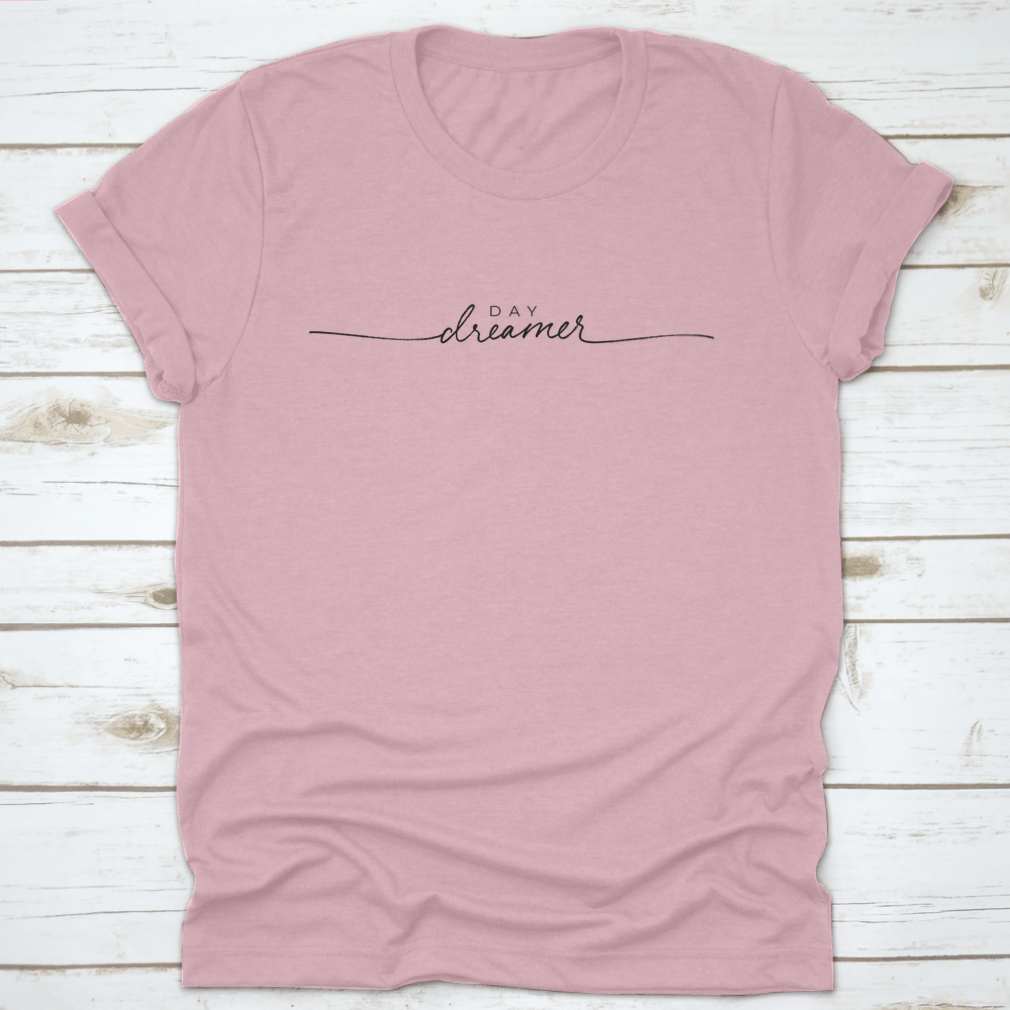 A stylish t-shirt featuring hand-drawn Day Dreamer vector line calligraphy lettering, showcasing creativity and comfort.