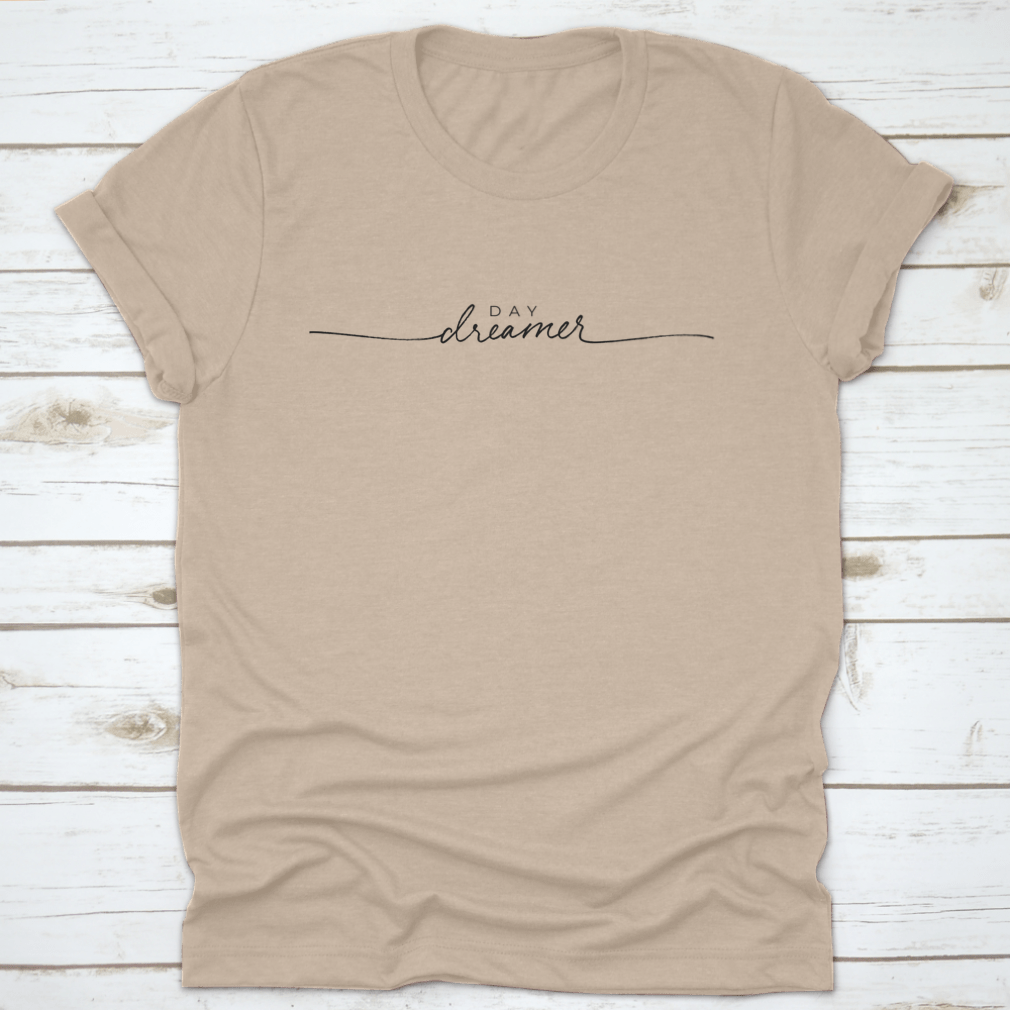 A stylish t-shirt featuring hand-drawn Day Dreamer vector line calligraphy lettering, showcasing creativity and comfort.