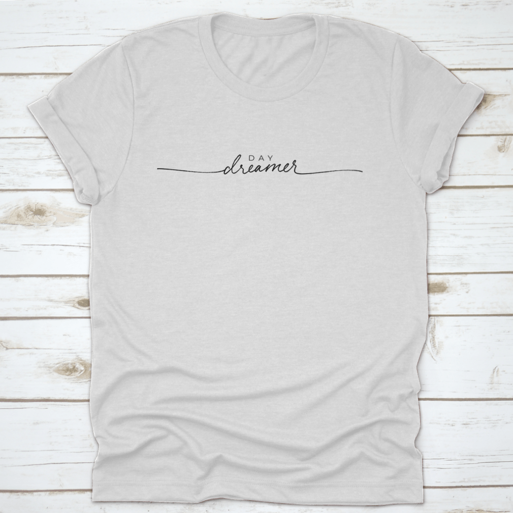 A stylish t-shirt featuring hand-drawn Day Dreamer vector line calligraphy lettering, showcasing creativity and comfort.