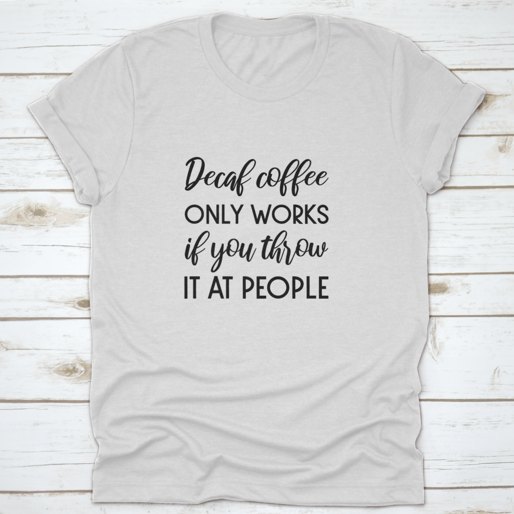 A humorous typography design shirt featuring the phrase 'Decaf Coffee Only Works If You Throw It At People', made from soft cotton fabric.