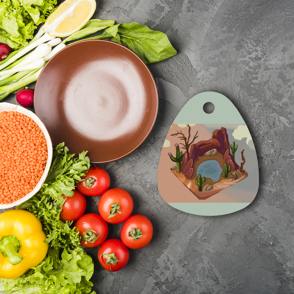 Desert Rocks Sublimation Glass Cutting Board with a water droplet shape, featuring a smooth surface for custom designs and four rubber feet for stability.