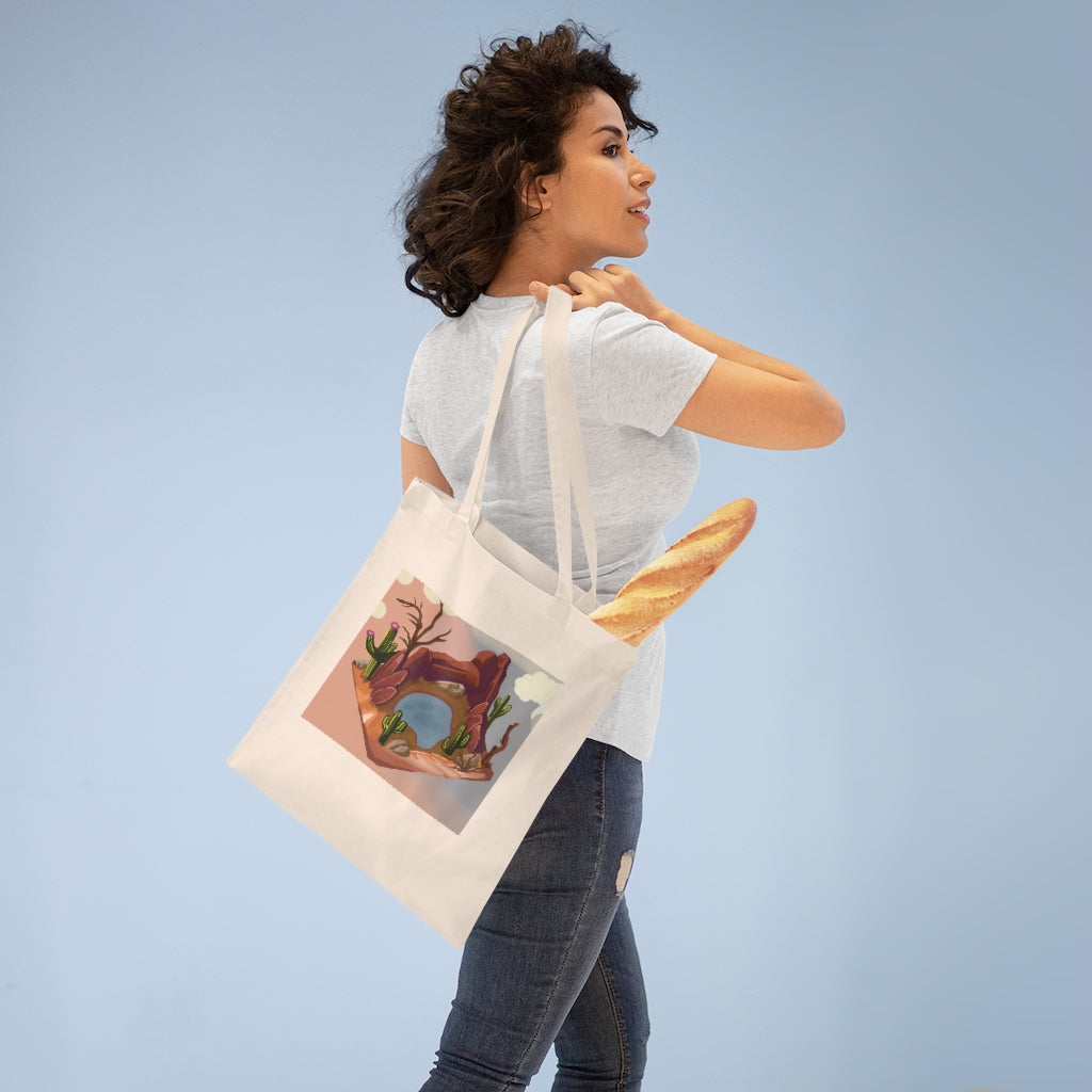 A stylish Desert Tote Bag made from 100% cotton, featuring long handles and cross stitching for added durability, available in various colors.