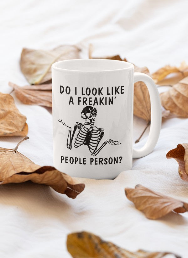 A humorous ceramic mug with the phrase 'Do I Look Like A Freakin Mug' printed on it, featuring a glossy finish and sturdy handle.