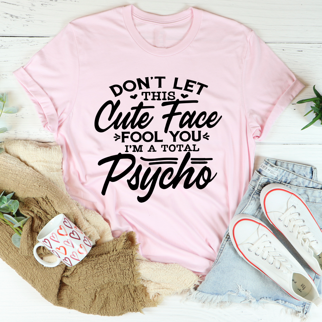 A stylish t-shirt featuring a playful design with the phrase 'Don't Let This Cute Face Fool You', made from soft ring-spun cotton.