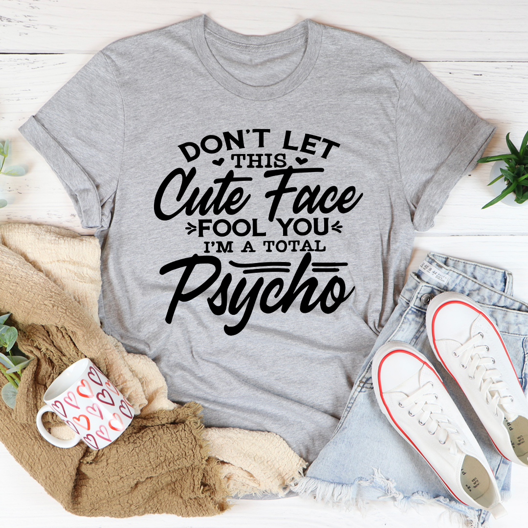 A stylish t-shirt featuring a playful design with the phrase 'Don't Let This Cute Face Fool You', made from soft ring-spun cotton.