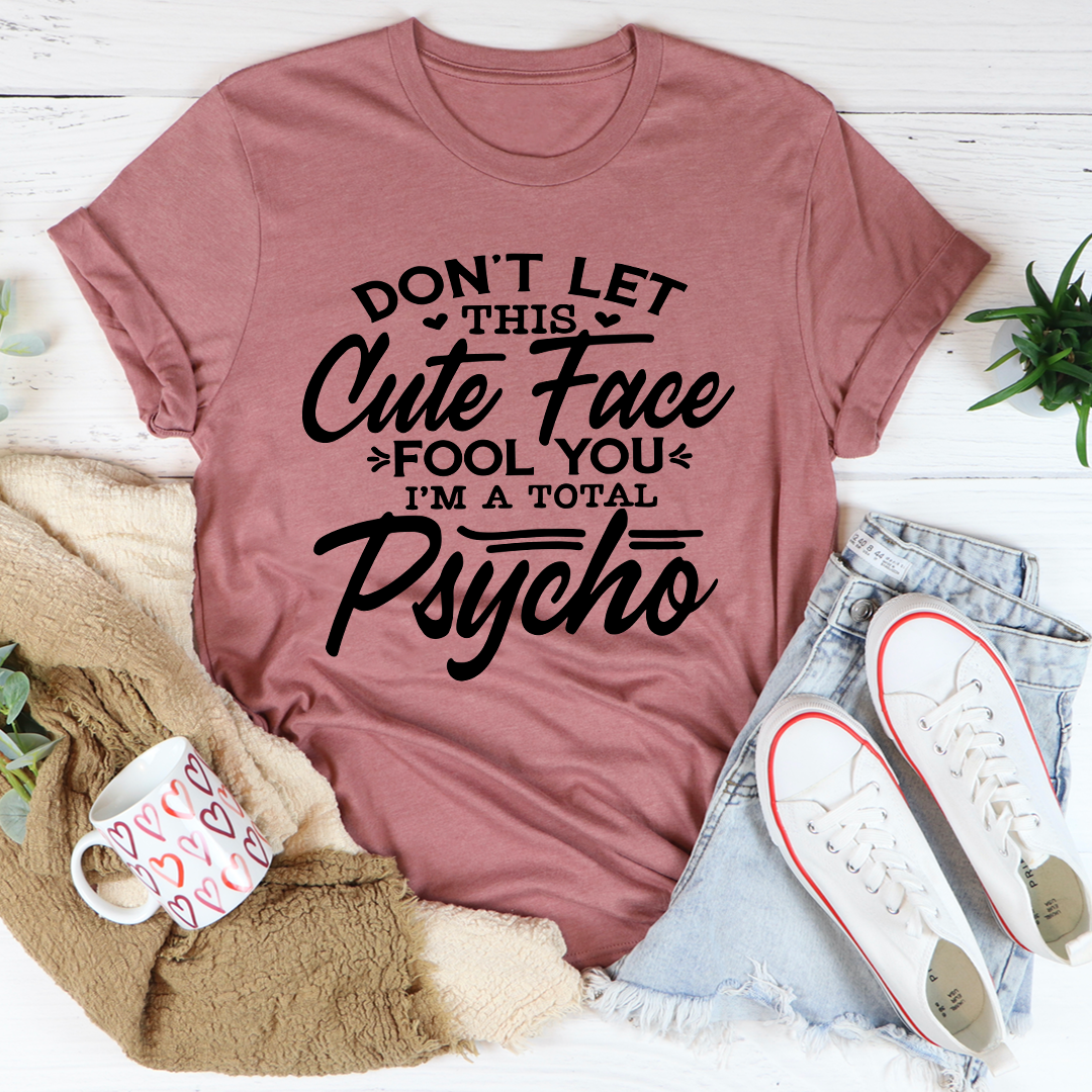 A stylish t-shirt featuring a playful design with the phrase 'Don't Let This Cute Face Fool You', made from soft ring-spun cotton.