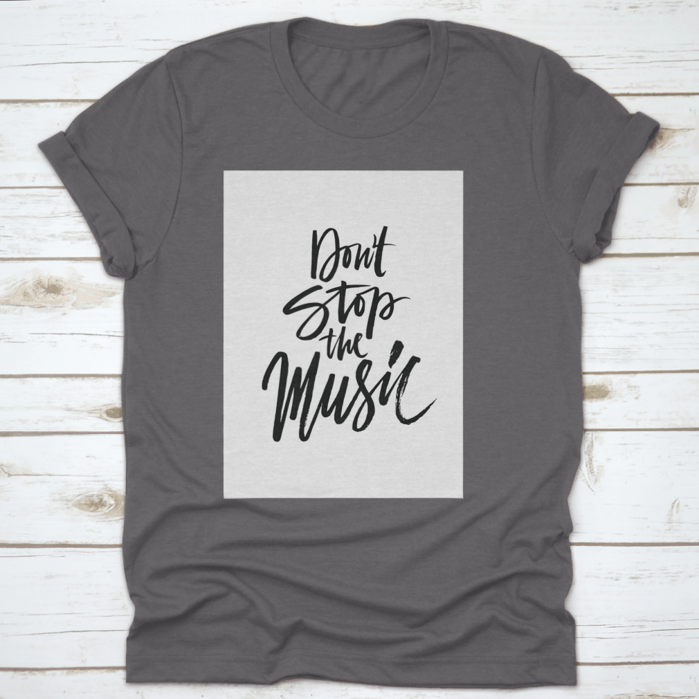 A stylish shirt featuring a hand-drawn quote 'Don'T Stop The Music' in a unique brush pen design, made from soft cotton fabric.