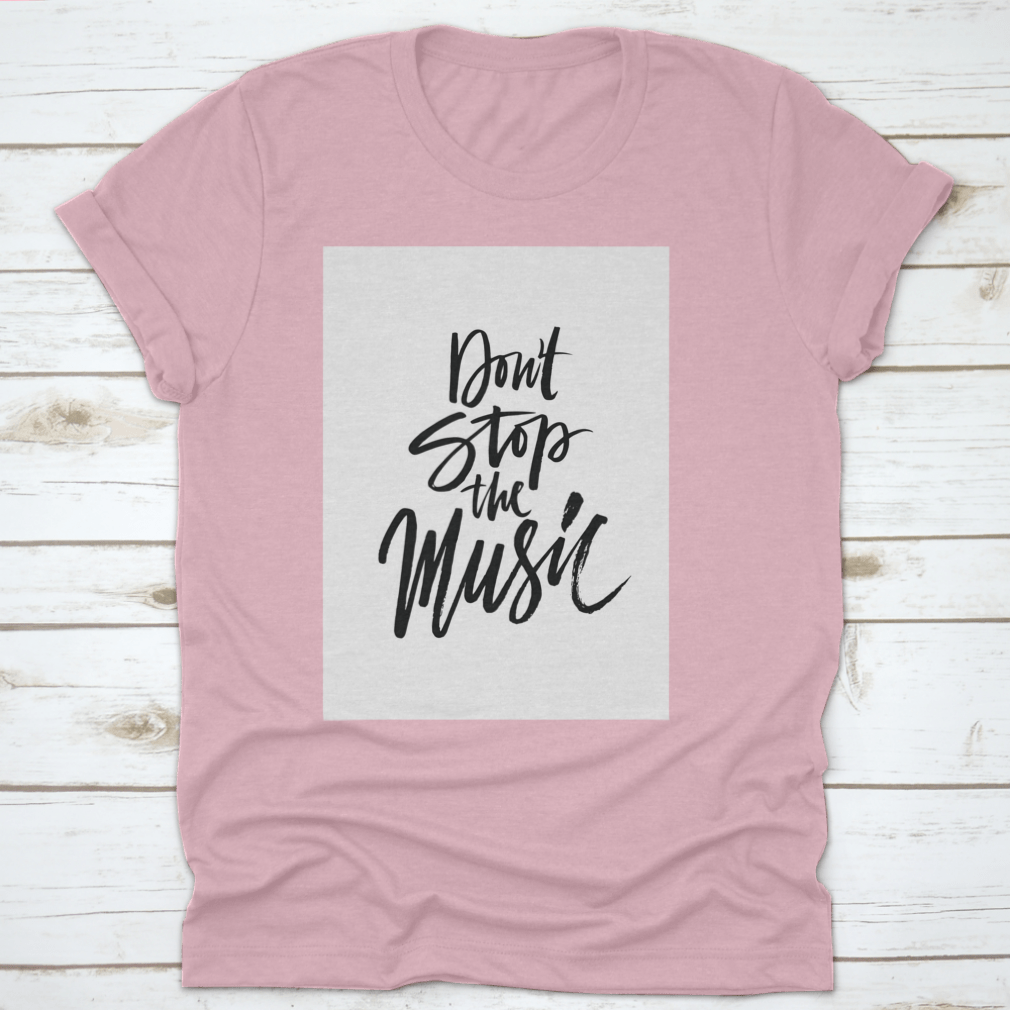 A stylish shirt featuring a hand-drawn quote 'Don'T Stop The Music' in a unique brush pen design, made from soft cotton fabric.