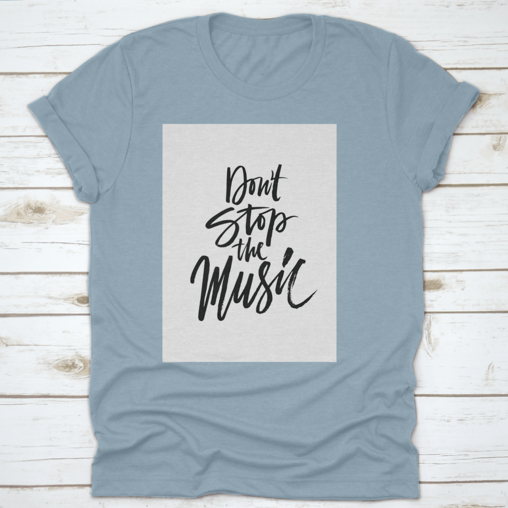 A stylish shirt featuring a hand-drawn quote 'Don'T Stop The Music' in a unique brush pen design, made from soft cotton fabric.