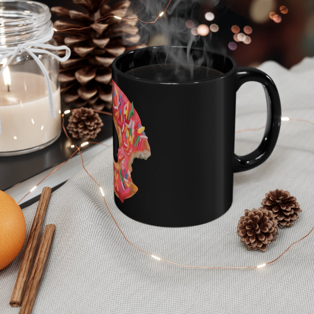 A sleek black ceramic mug with a C-handle, perfect for coffee or tea, showcasing its 11oz capacity and customizable design.