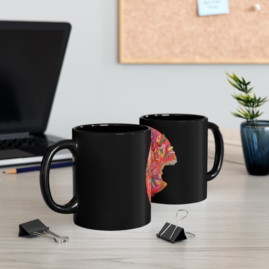 A sleek black ceramic mug with a C-handle, perfect for coffee or tea, showcasing its 11oz capacity and customizable design.