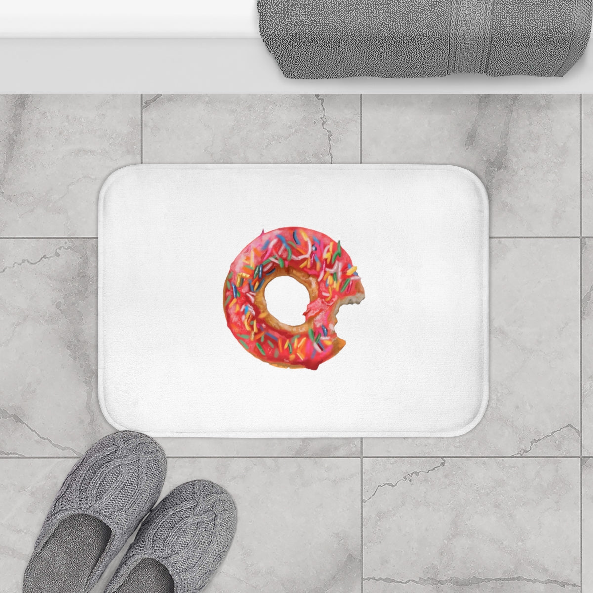 A colorful donut-shaped bath mat with anti-slip backing, designed for bathroom safety and style.