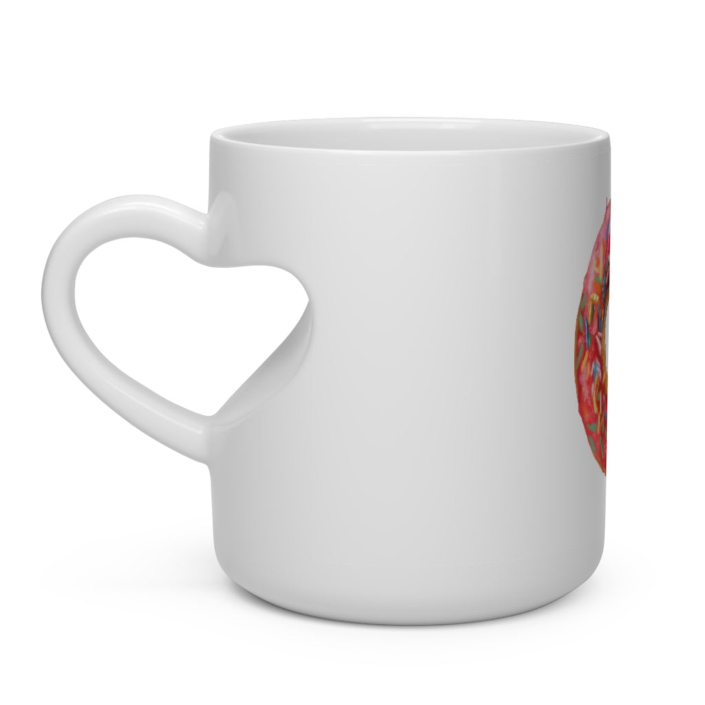 A white ceramic mug shaped like a heart with a heart-shaped handle, perfect for hot beverages.