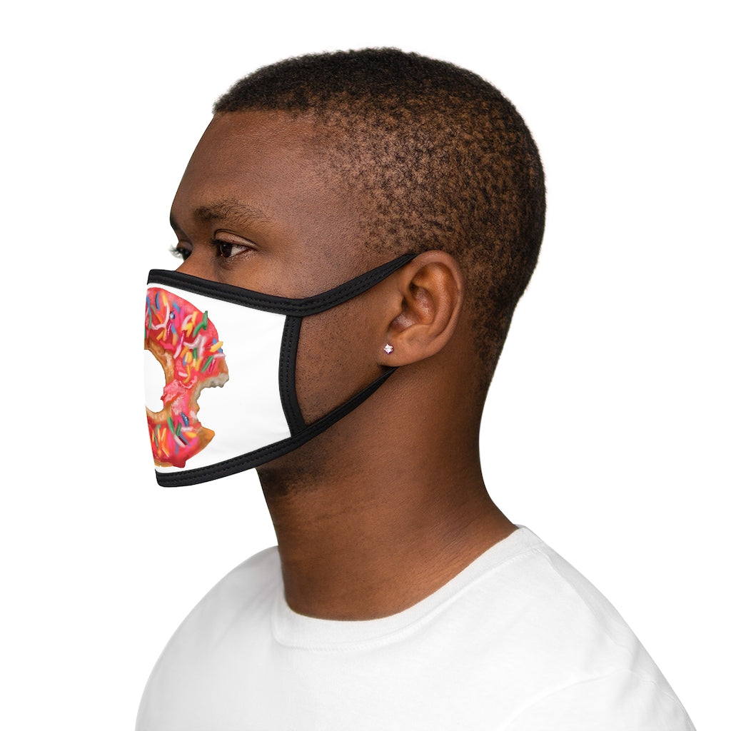 A colorful donut-patterned face mask with a black outer edge and earloops, showcasing a fun and stylish design.