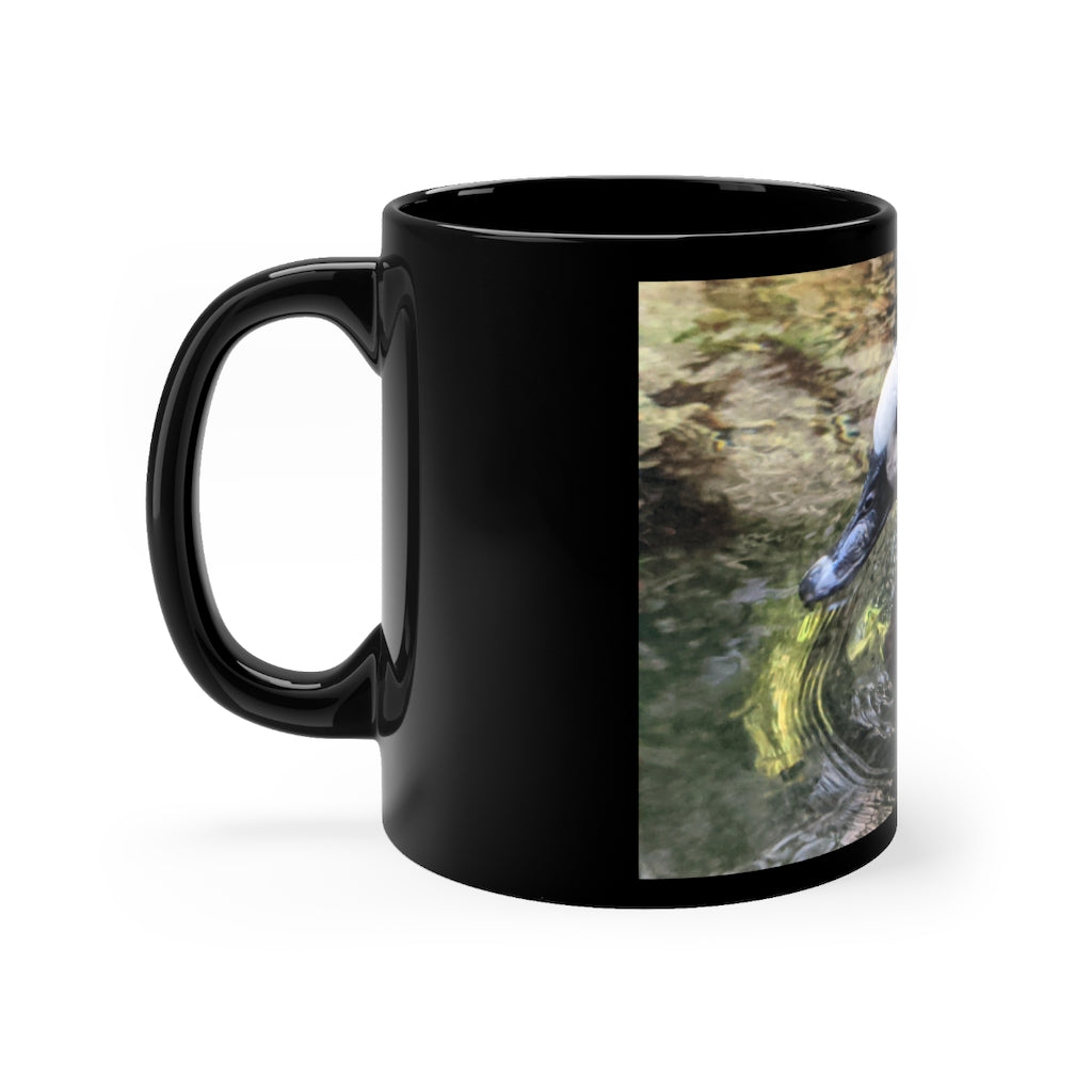 A sleek 11oz black ceramic mug with rounded corners and a C-handle, featuring a full-wrap design for personalization.