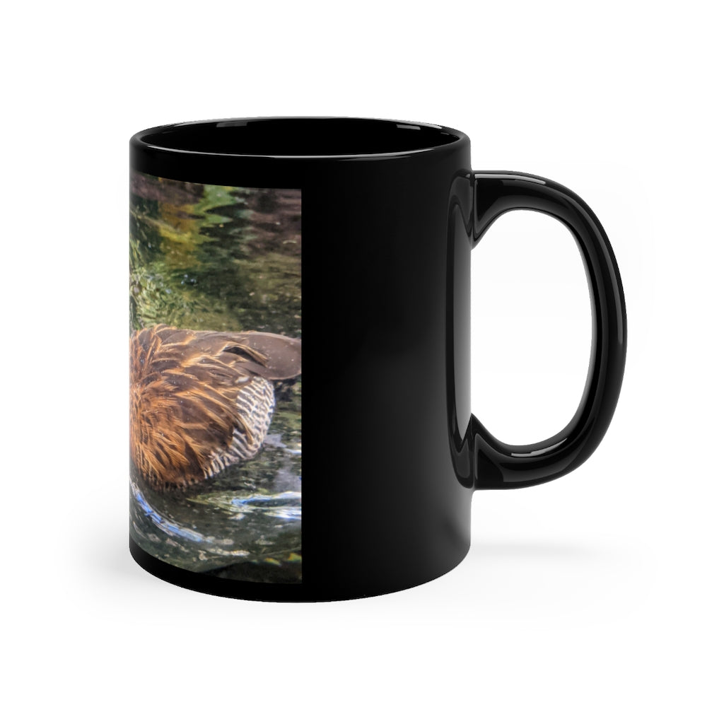 A sleek 11oz black ceramic mug with rounded corners and a C-handle, featuring a full-wrap design for personalization.