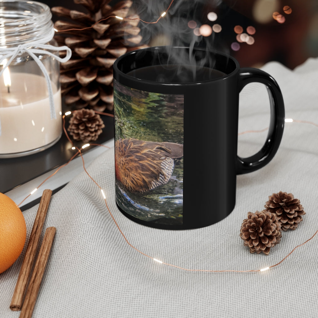 A sleek 11oz black ceramic mug with rounded corners and a C-handle, featuring a full-wrap design for personalization.