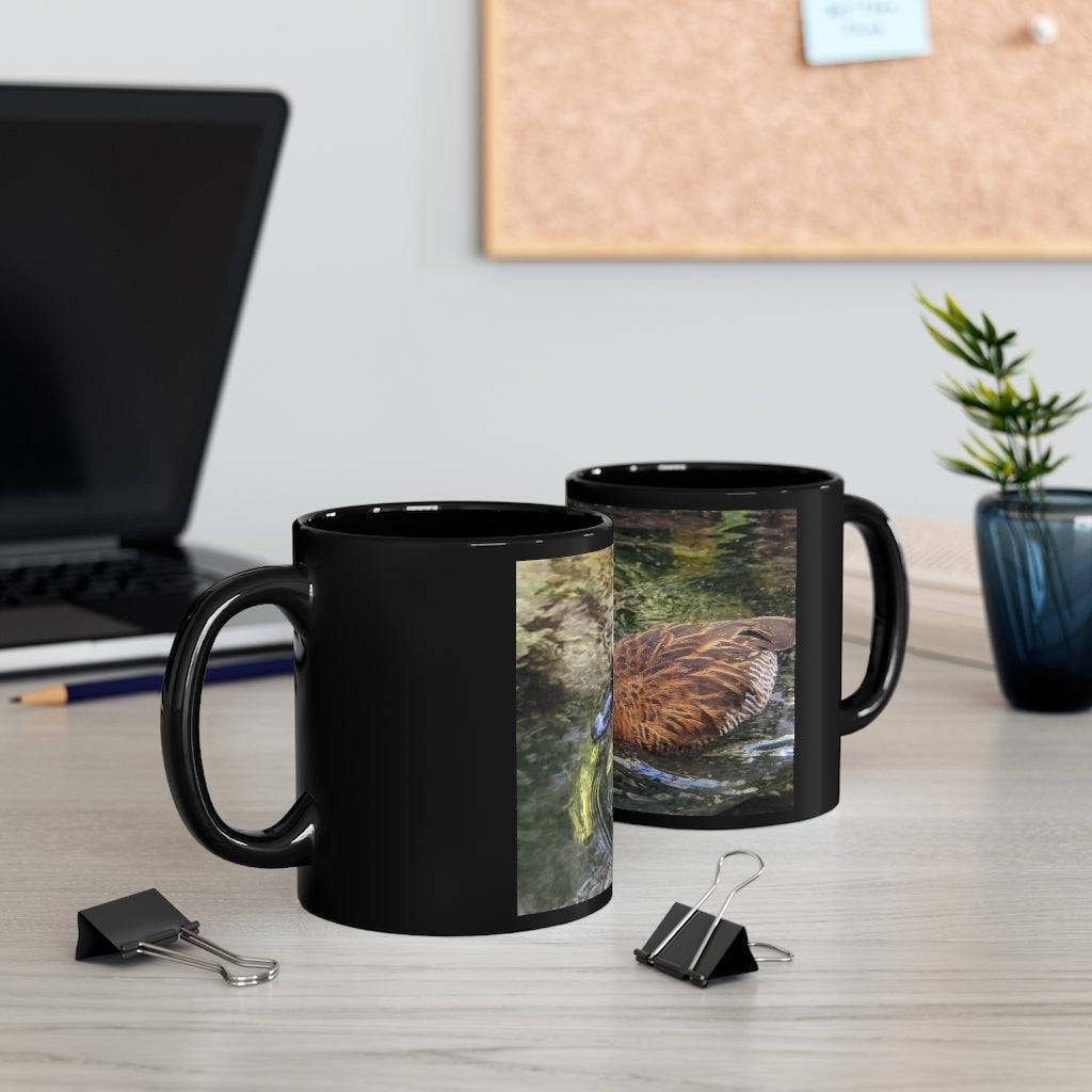 A sleek 11oz black ceramic mug with rounded corners and a C-handle, featuring a full-wrap design for personalization.