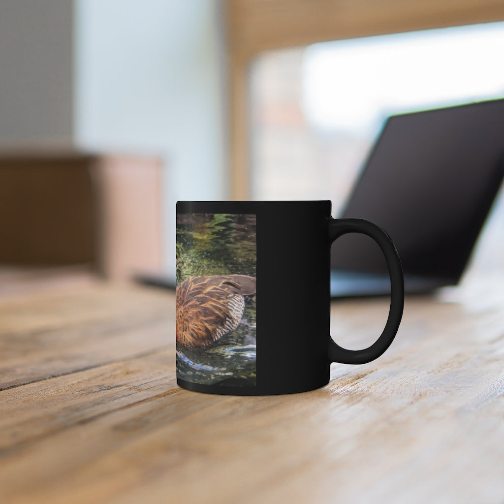 A sleek 11oz black ceramic mug with rounded corners and a C-handle, featuring a full-wrap design for personalization.